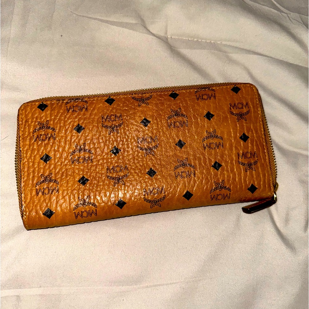 MCM signature monogram wallet with a secure zip-around closure.